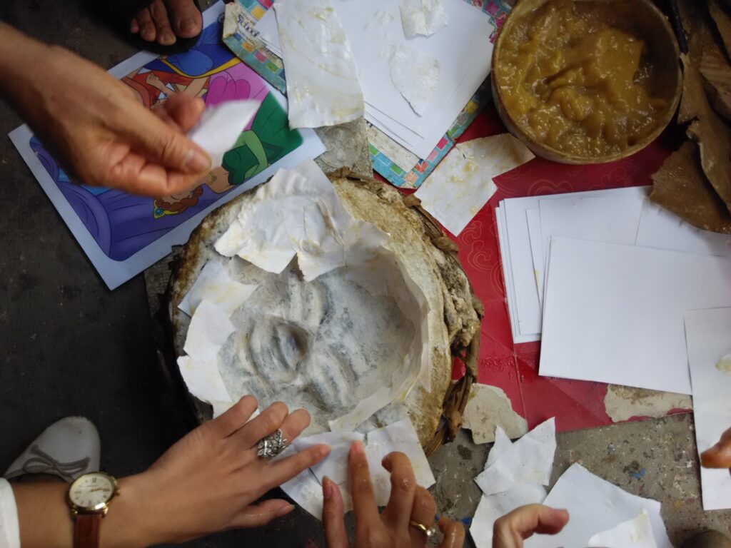 2. Start by attaching paper with glue onto the mould